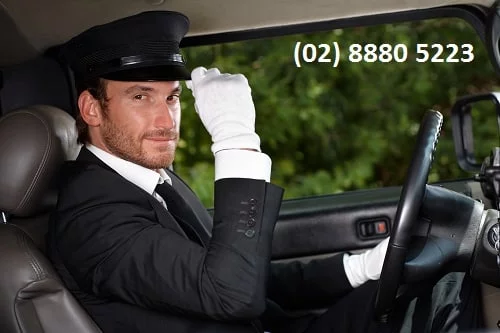 Sydney Chauffeur wearing white gloves and hat driving a Sydney Limo